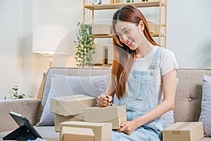 Asian women SME freelance working with packaging startup entrepreneur small business owner at home,Online business seller