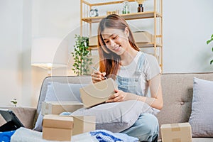 Asian women SME freelance working with packaging startup entrepreneur small business owner at home,Online business seller photo