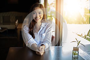 Asian women smiling and happy Relaxing in a coffee shop after working in a successful office photo