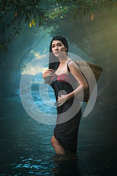 Asian women standing in creek