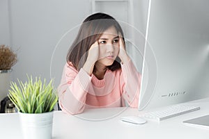 Asian women stressful working with a computer for a long time,Of
