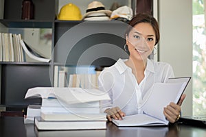 Asian women student smiling and reading a book for relaxation