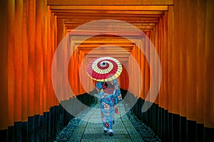 Asian women in traditional japanese kimonos at Fushimi Inari Shrine in Kyoto, Japan.