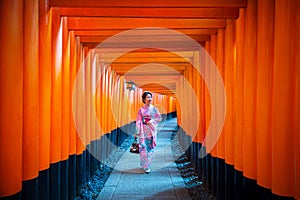 Asian women in traditional japanese kimonos at Fushimi Inari Shrine in Kyoto, Japan