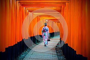 Asian women in traditional japanese kimonos at Fushimi Inari Shrine in Kyoto, Japan