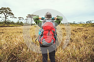 Asian women travel  nature. Travel relax.Backpack walk on the meadow in the forest. Thailand