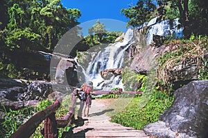 Asian women travel nature. Travel relax. Photograph waterfall travel. In the summer. Thailand
