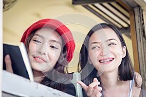 Asian women traveler have reading a book and talking in the trai