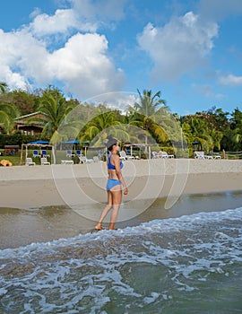 Asian women walking at the beach on vacation Saint Lucia, luxury holiday Saint Lucia Caribbean