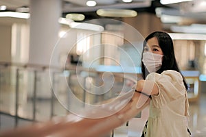 Asian women wear surgical face masks to protect The Covid-19 in public areas