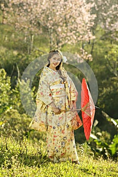 Asian women wearing traditional japanese kimono and red umbrella