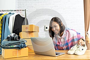 Asian women working laptop computer selling shoes online start up small business owner
