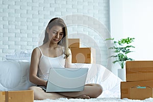 Asian women working with laptop for Online shopping at home with box for packaging in home,Own Small Business Start up for Online