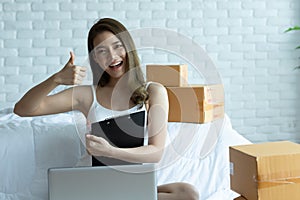 Asian women working with laptop for Online shopping at home with box for packaging in home,Own Small Business Start up for Online