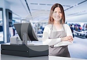 Asian worker with cashier desk