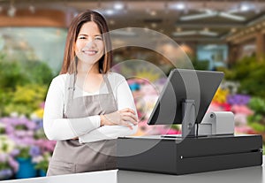 Asian worker with cashier desk