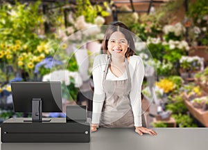 Asian worker with cashier desk