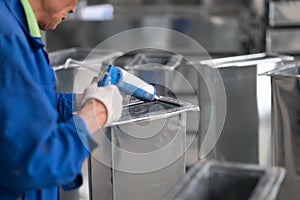 Asian Worker Caulking Wearing Blue Uniform