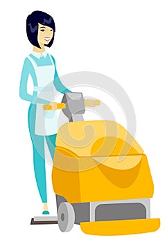 Asian worker cleaning store floor with machine.