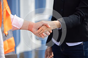 Asian Worker Having a Hand Shake with His Female Manager at Container Cargo Site