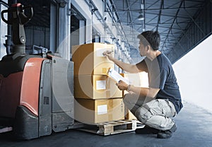 Asian Worker Holding Clipboard His Doing Inventory Management at Storage Warehouse. Checking Stock Package Boxes.