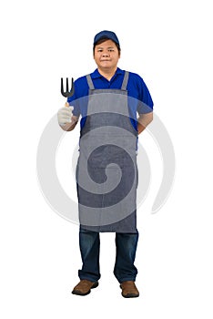 Asian worker man in blue shirt with apron and protective gloves hand holding Shoveling fork isolated on white