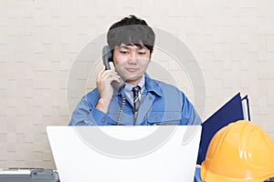 Asian worker with a phone