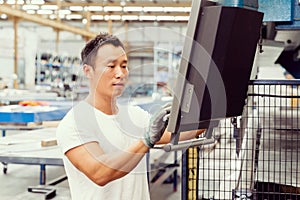 Asian worker in production plant on the factory