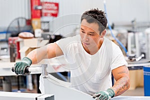 Asian worker in production plant on the factory floor