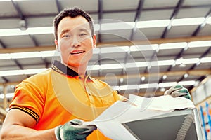 Asian worker in production plant on the factory floor