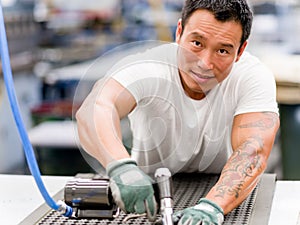 Asian worker in production plant on the factory floor