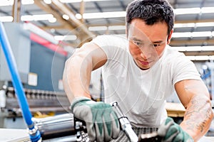 Asian worker in production plant on the factory floor