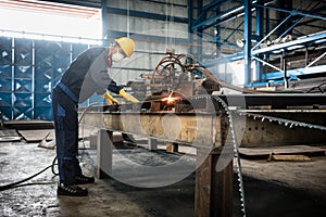 Asian worker using CNC plasma cutter