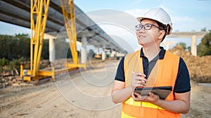 Asian worker using digital tablet at construction site