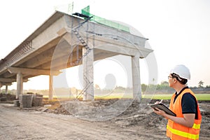 Asian worker using digital tablet at construction site