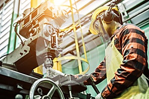 Asian worker wearing the goggle, helmet, ear muff equipment in production plant