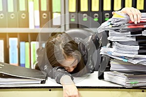 Asian worker woman sleeping on the workplace, tired woman asleep from working hard, Lot of work, . photo