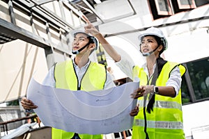 Asian workers people walking and checking onsite of architecture building straucture and work progress. Male and female engineers photo