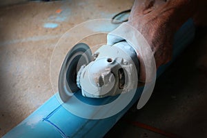 Asian workers use circular saw cutting the PVC pipe