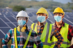 Asian workers wear protective face masks for safety in Construction site Electricity Solar power industry, Natural energy, New