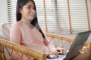 Asian working woman is working on her labtop Working from home with relax