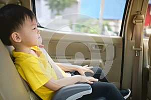 Asian 3 - 4 years old toddler boy child sitting in booster car seat, Happy traveling, Child passenger safety, Safe way to travel