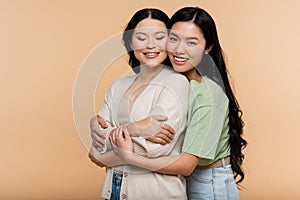 asian young adult daughter hugging pleased