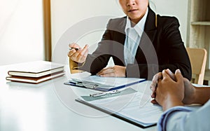 Asian young adult sitting at desk across from manager being interviewed job interview in business room