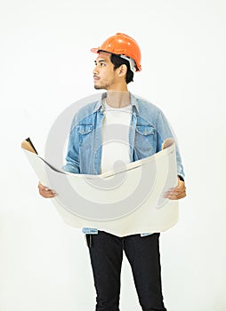 Asian young architect man in casual jeans wear orange color hardhat looking away with happy and smile face while holding