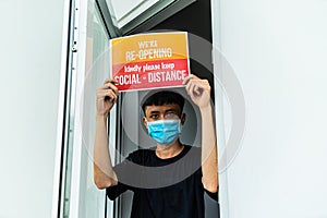 Asian young asian man setting open sign at the shop glasses for welcome the customer in to the coffee shop, store, small business