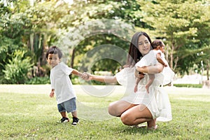 Asian young beautiful mother holding her newborn is sleeping and feel with love and touching gently