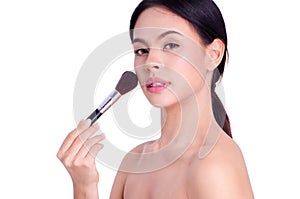 Asian young beautiful woman looking and touch her chin with powder brush,natural makeup, skincare, cosmetology and plastic surgery