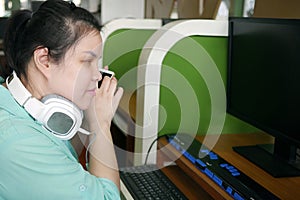 Asian young blind person woman with headphone using smart phone with voice assistive technology for disabilities persons in photo