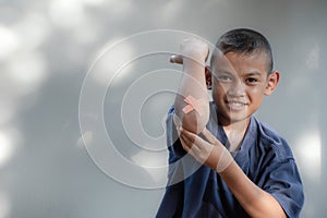 Asian young boy sitting have wound on elbow from accident on blur background,Children and accident,Boy smile and charming,playing